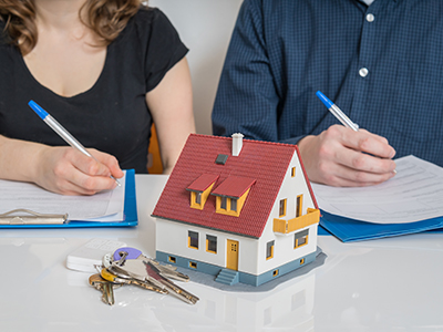 parents signing a real estate contract
